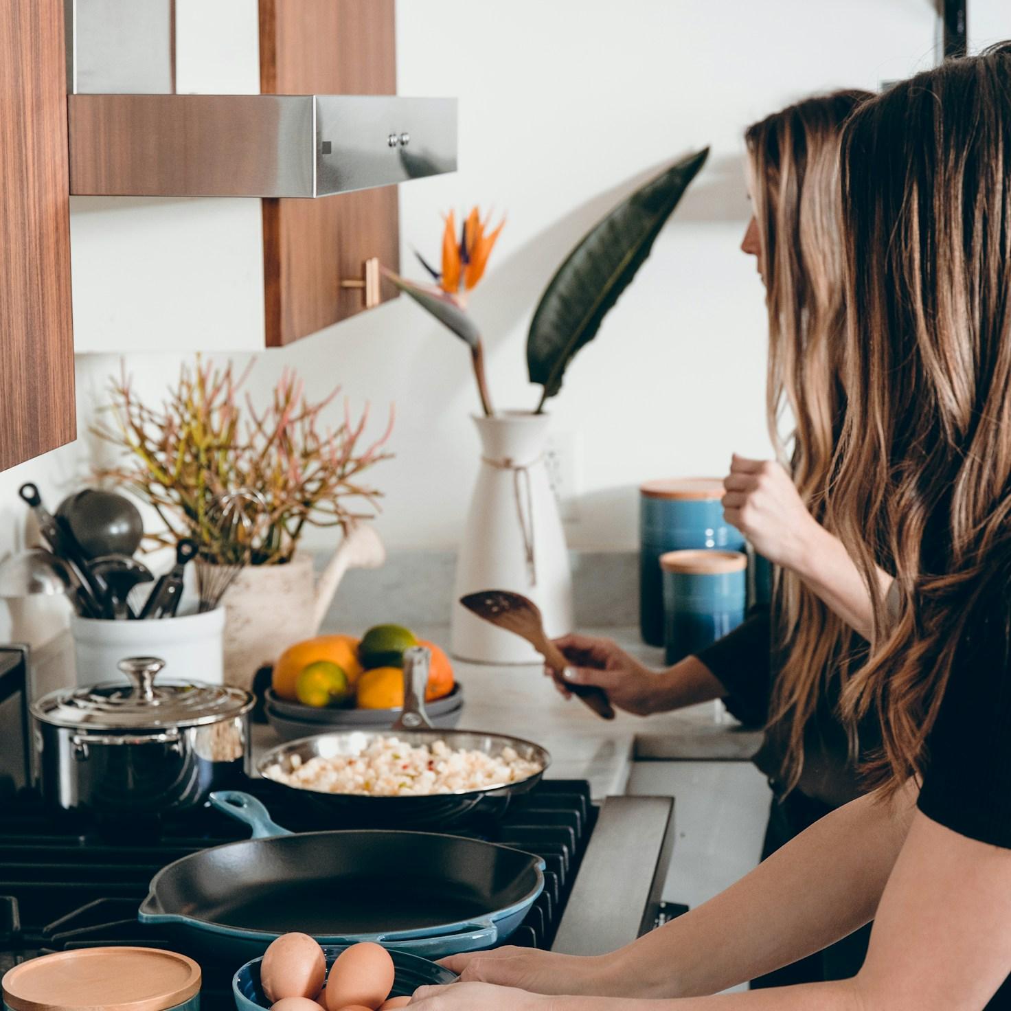 Community members collaborating in a modern kitchen space, sharing recipes and cooking techniques